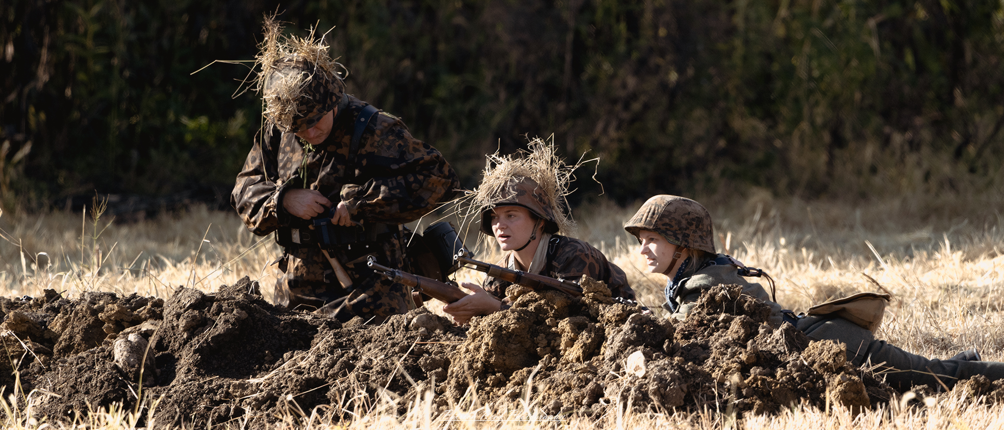 "Female German soldiers in a field, dressed in WWII-era uniforms. They are engaged in various activities such as strategizing, tending to equipment, and surveying their surroundings. The backdrop features a war-torn landscape, highlighting their roles and contributions during the conflict, while conveying a sense of camaraderie and resilience."